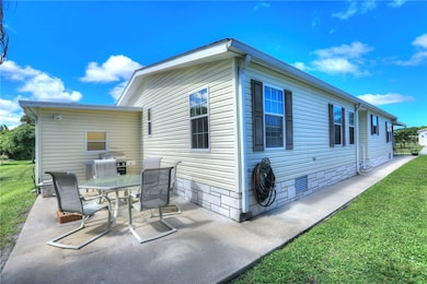 View of property exterior with crawl space, a yard, and a patio area
