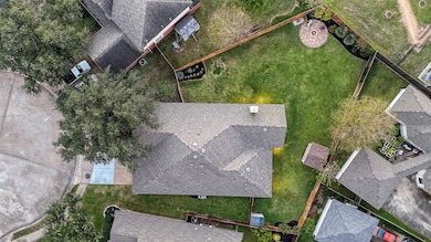 Aerial view showcasing the brand new roof (Oct 2025) spacious fenced backyard, and cul-de-sac location offering added privacy and minimal traffic.