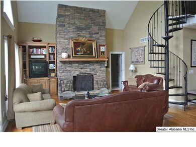 LOOKING TO GREAT ROOM.  STONE FIREPLACE AND SPIRAL