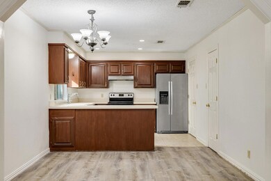Kitchen with a sink, an inviting chandelier, light