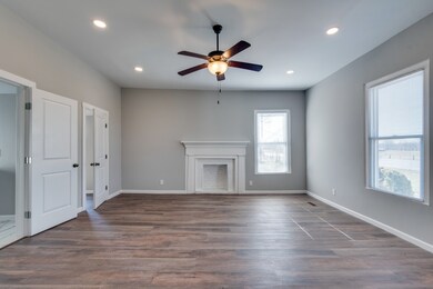 The 19x17 Master en suite has recessed can lighting, one of the homes two remaining fireplaces and mantel, a walk in closet, and tastefully done tile work in the bathroom.