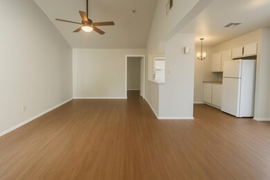 Unfurnished living room featuring ceiling fan, wo