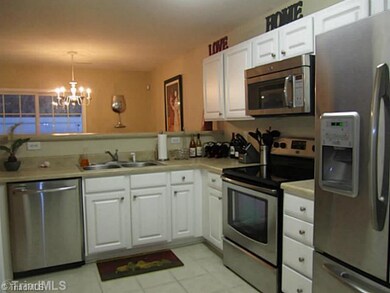Kitchen. Stainless appliances stay!  Laundry behind doors on wall opposite refrigerator