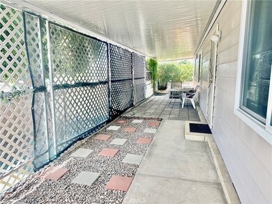Covered Side patio has lattice and darkening shade screens