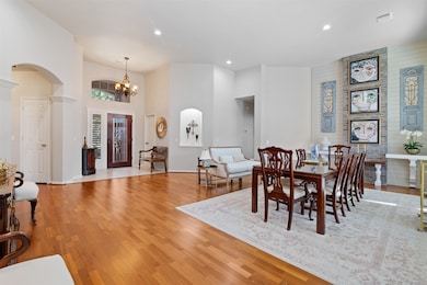 View of the spacious dining room with decorative shiplap and brick accent wall . Dining room features hardwood floors, canned lighting and lit art niche. This room is so grand you can use it as a second sitting area and dining together.