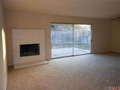 Living room fireplace.  sliding glass door to rear