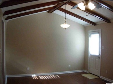 The large family room features wood floors, vaulted ceilings with crown molding, ceiling fan and new back door. Great for entertaining family and friends.
