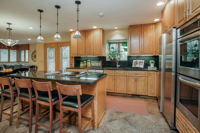Cooks kitchen with large island opens to family ro
