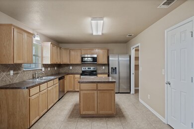 Kitchen featuring stainless steel appliances, lig