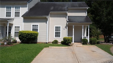 View of front of house with a porch, a front lawn, and a shingled roof