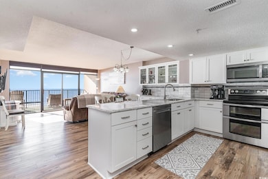Kitchen with floor to ceiling windows, sink, light