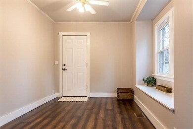Dining room with large bay window, door leads to o