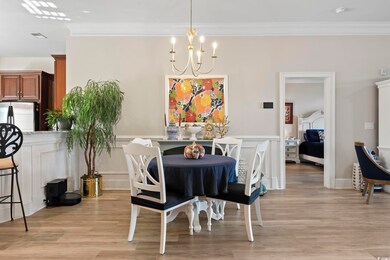 Dining space featuring a chandelier, crown molding