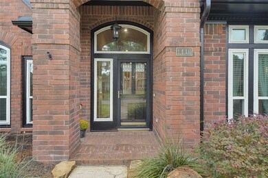 Approaching the front door you will see the beautiful brick elevation, covered front porch, and dark stained front door, and upgraded windows!