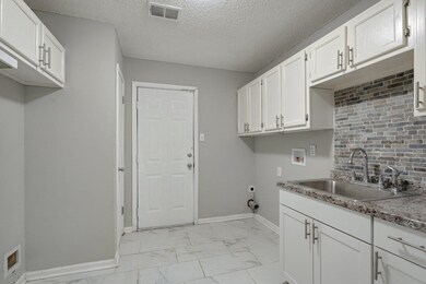 Kitchenwith hookup for an electric dryer, cabinets