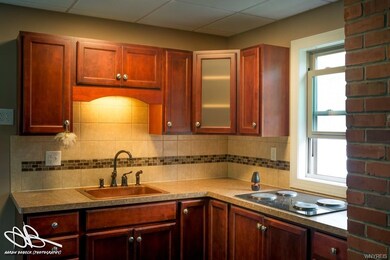 Beautifully updated with glass tile trim on cerami