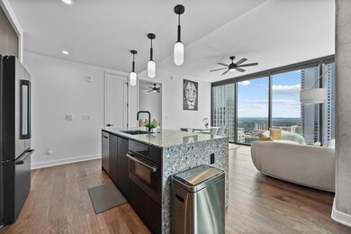 Kitchen featuring a ceiling fan, a sink, stainles