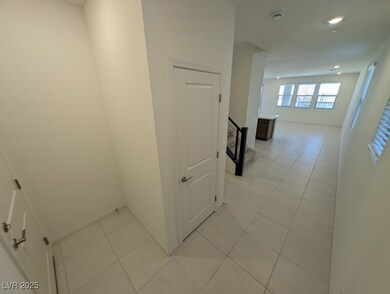 Hallway with light tile patterned flooring, recessed lighting, and stairway