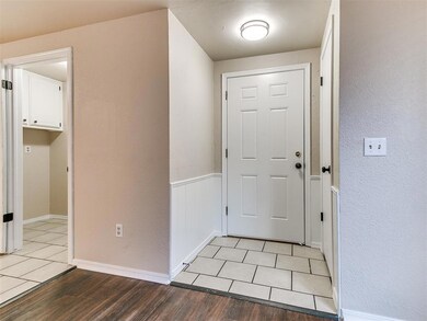 Tiled entry with coat closet