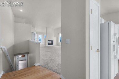 Hall featuring an upstairs landing, baseboards, carpet floors, and recessed lighting