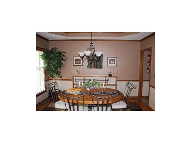 Formal dining room with hardwood floors.