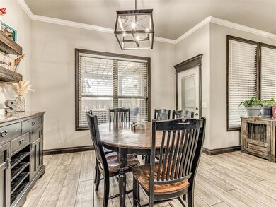 Dining area featuring crown molding, light hardwoo