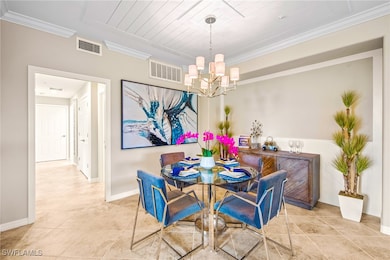 Tiled dining space with crown molding, visible ven