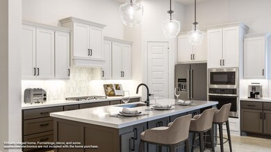 Kitchen with light countertops, custom range hood