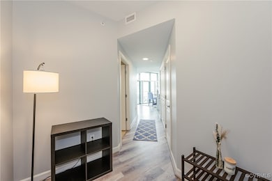 Hallway with recessed lighting, baseboards, light