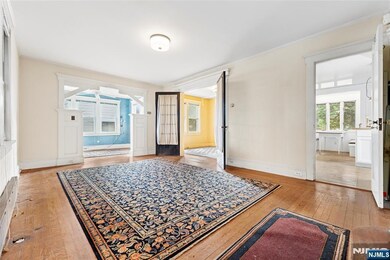 Living Room + French Doors leading to Formal Dining Room + Entrance to Kitchen