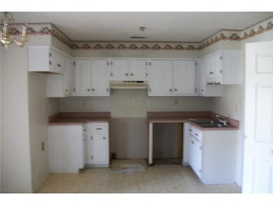 This kitchen has lot of cabinets and countertops!