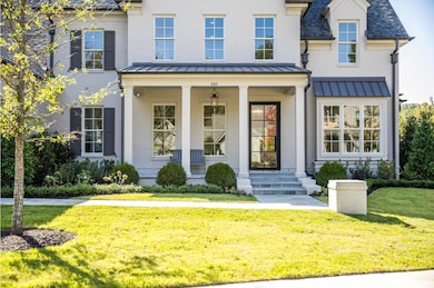 View of front of property featuring a porch and a front yard