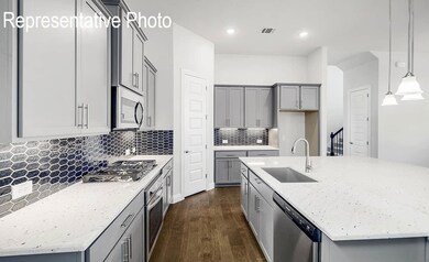 Kitchen with decorative light fixtures, dark wood-