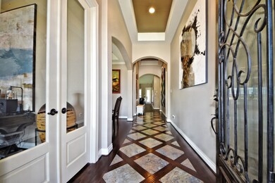 What a Wow Factor when you enter into this Custom Home!  Dramatic Entry with High Coffered Ceilings, Upgraded 8  Foot Glass French Doors that leads into your Outstanding Study!  Stunning Tile & Wood Floors inlay, just amazing! Upgraded Two Tone Interior Paint and more!