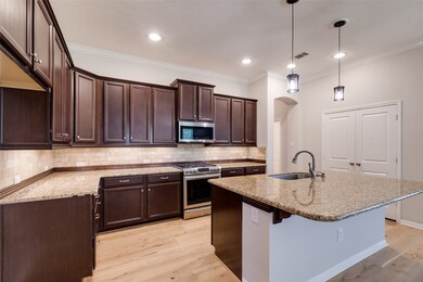 A chef's dream, this Kitchen has attention to detail such as custom granite counter tops, subway tile backsplash trimmed in wood molding and pendant lighting.