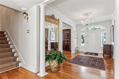 View of foyer, front door and stairwell to upper f