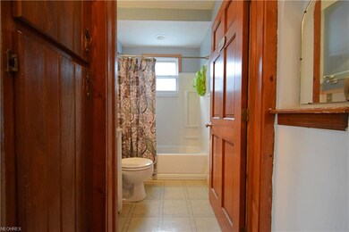 Bathroom has added storage just outside the door.