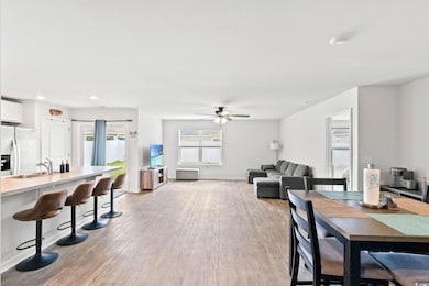 Dining space with light wood-style floors, ceiling fan, and recessed lighting