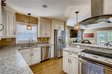 Kitchen features granite counters, soft-close cabinets and drawers, S/S appliances and island.