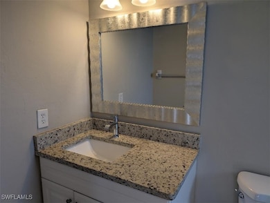 Half bath with vanity and toilet