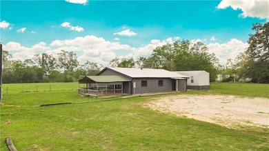Back of property with dirt driveway and view of sc