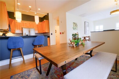 Open concept dining space featuring pendent and tr