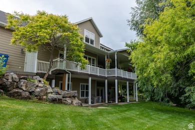 Rear view of property featuring a lawn and a patio area