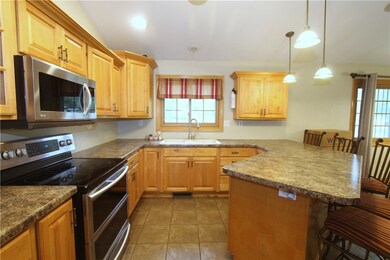 Kitchen features maple cabinets.