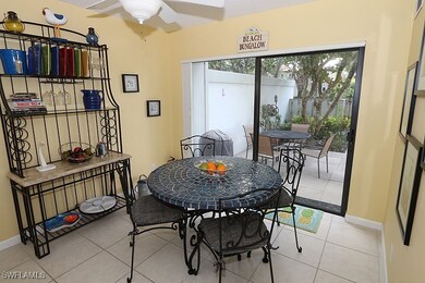 Tiled dining room featuring ceiling fan and basebo
