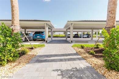 View of community featuring covered parking