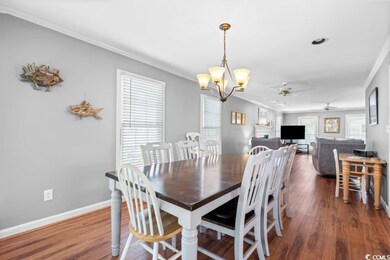 Dining space featuring ceiling fan with notable ch