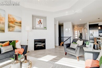 Living room featuring a fireplace, light wood-style floors, and recessed lighting