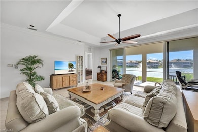 Living room with ceiling fan, light tile patterned