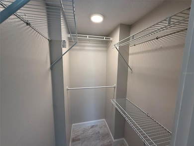 Primary bedroom walk in closet